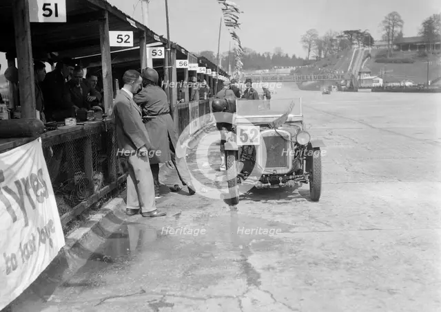 Austin Ulster of ECH Randall and WE Harker in the pits, JCC Double Twelve race, Brooklands, 1931. Artist: Bill Brunell.