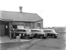 Austin vans being loaded outside Clays TV repair depot, Mexborough, South Yorkshire, 1959. Creator: Michael Walters