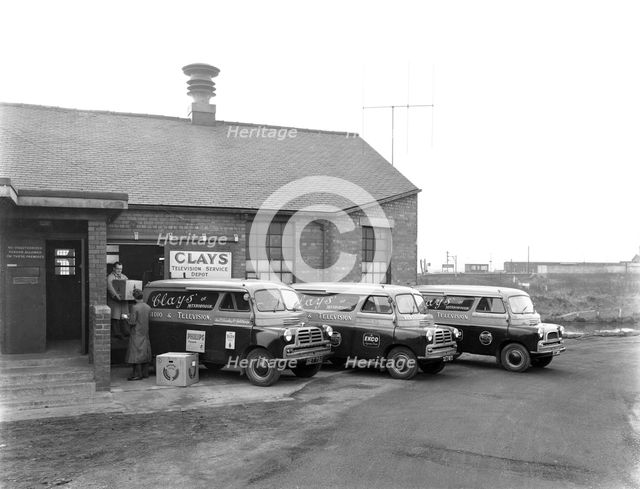 Austin vans being loaded outside Clays TV repair depot, Mexborough, South Yorkshire, 1959. Artist: Michael Walters