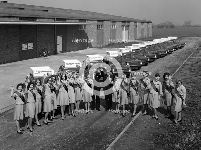 Australian sales girls in front of a fleet of 1965 Hillman Imps, Selby, North Yorkshire, 1965. Creator: Michael Walters.