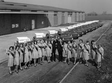 Australian sales girls in front of a fleet of 1965 Hillman Imps, Selby, North Yorkshire, 1965. Creator: Michael Walters