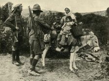 Australian soldier giving water to a Turkish family, First World War, 1915-1916, (c1920). Creator: Unknown