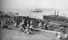 'Austrian prisoners taken by Serbians resting at mid-day on the banks of the Danube 1915