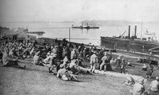 'Austrian prisoners taken by Serbians resting at mid-day on the banks of the Danube 1915