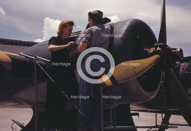 Bowen, a riveter, and Olsen, her supervisor, in the Assembly...Air Base, Corpus Christi, Texas, 1942 Creator: Howard Hollem.
