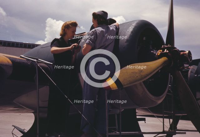 Bowen, a riveter, and Olsen, her supervisor, in the Assembly...Air Base, Corpus Christi, Texas, 1942 Creator: Howard Hollem.
