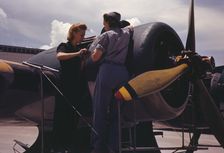 Bowen, a riveter, and Olsen, her supervisor, in the Assembly...Air Base, Corpus Christi, Texas, 1942 Creator: Howard Hollem