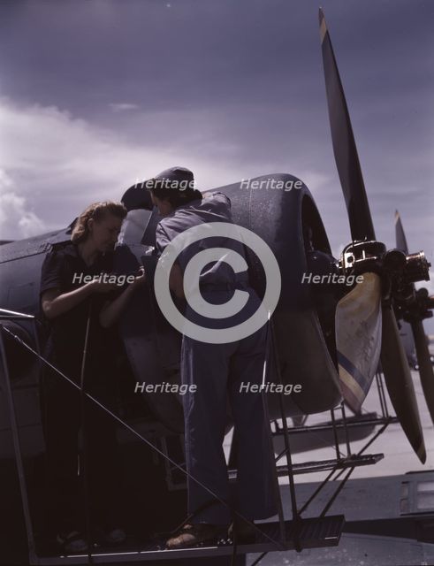 Bowen and Olsen, a riveter and her supervisor, in the...Naval Air Base, Corpus Christi, Texas, 1942. Creator: Howard Hollem.