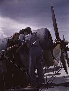Bowen and Olsen, a riveter and her supervisor, in the...Naval Air Base, Corpus Christi, Texas, 1942. Creator: Howard Hollem