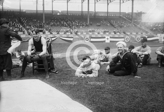 Boxer Joe Welling, amid Cleveland baseball players in stadium, 1918. Creator: Bain News Service.