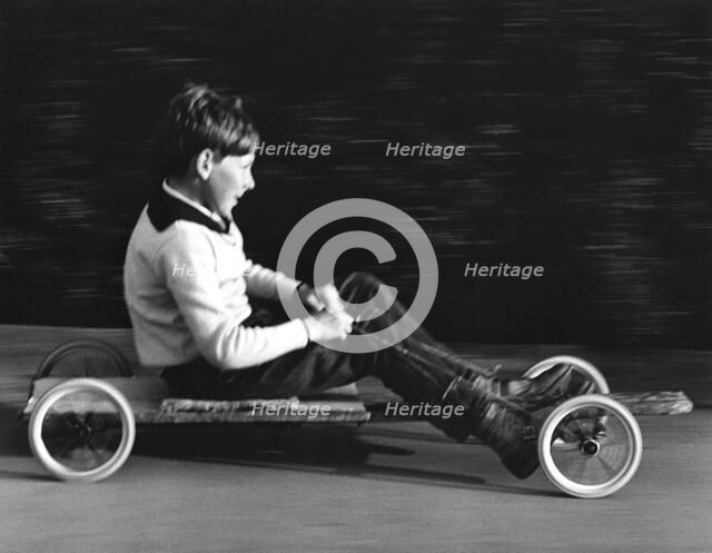 Boy driving a home-made go-kart, Horley, Surrey, 1965.