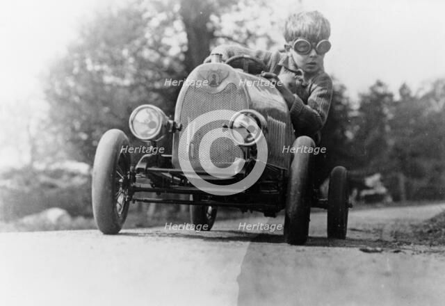Boy in a pedal car. Artist: Unknown