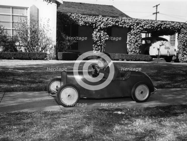 Boy in a pedal car. Artist: Unknown
