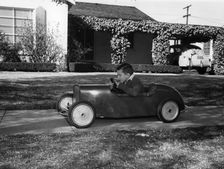 Boy in a pedal car