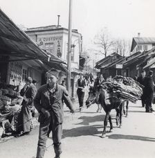 Boy leading a donkey along a street, Sarajevo, Bosnia-Hercegovina, Yugoslavia, 1939
