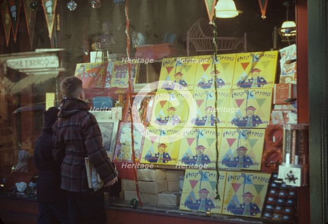 Boy looking at store window display of toys, between 1941 and 1942. Creator: Unknown.