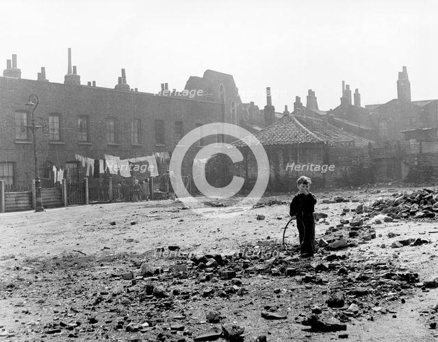 Boy playing on sewage works, East End, London, c1951. Creator: Henry Grant.
