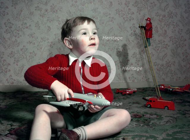 Boy playing with a toy aeroplane, c1960s. Creator: Arthur Charles Kirby Ware.