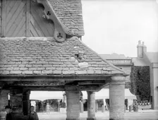 Boy poking his head through the roof of the 17th-century Buttercross, Witney, Oxon, c1860-c1922. Artist: Henry Taunt