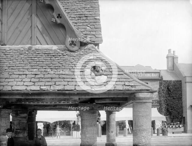 Boy poking his head through the roof of the 17th-century Buttercross, Witney, Oxon, c1860-c1922. Artist: Henry Taunt