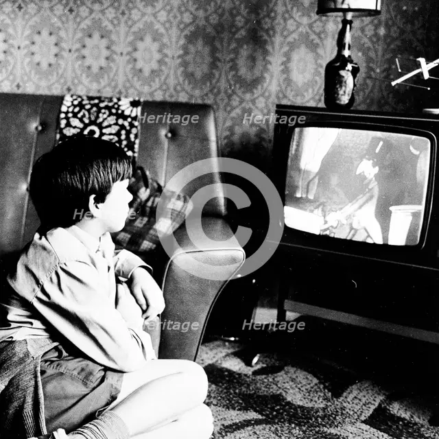 Boy watching television in a London house, c1950s. Creator: Henry Grant.