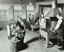 Boys using forges in a blacksmith's shop, Beaufoy Institute, London, 1911