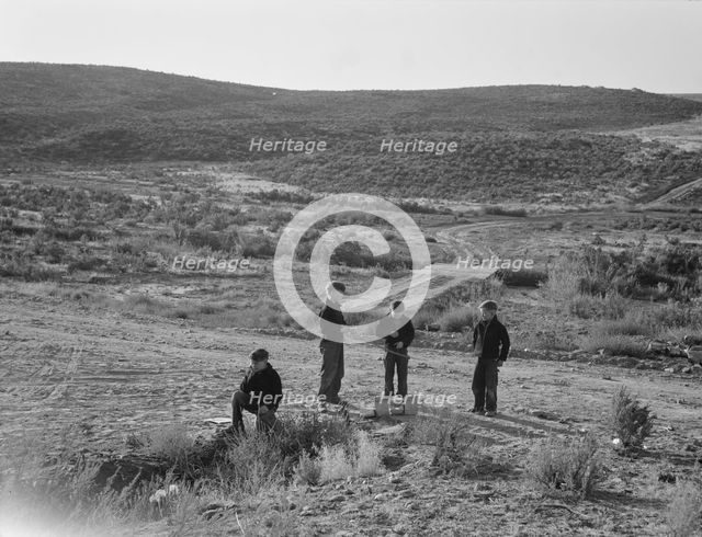 Boys wait for school bus in the morning, Malheur County, Oregon, 1939. Creator: Dorothea Lange.