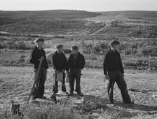 Boys wait for school bus in the morning, Malheur County, Oregon, 1939. Creator: Dorothea Lange
