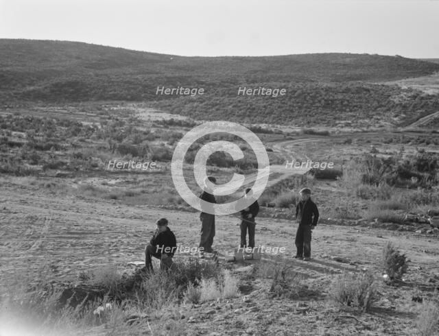 Boys wait for school bus in the morning, Malheur County, Oregon, 1939. Creator: Dorothea Lange.