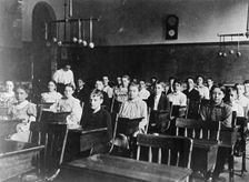 Boys and girls seated at desks in Washington, D.C. classroom, (1899?). Creator: Frances Benjamin Johnston