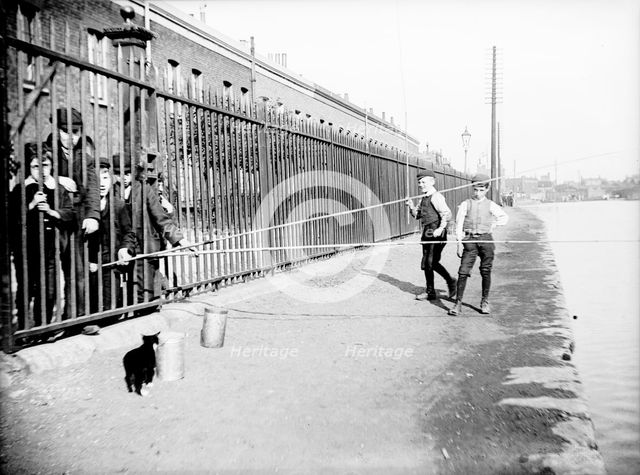 Boys fishing across a canal towpath, London, c1905. Artist: Unknown