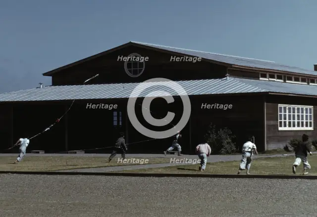 Boys flying a kite in front of community center, FSA ... camp, Robstown, Tex., 1942. Creator: Arthur Rothstein.