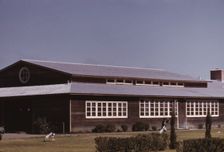 Boys flying a kite in front of the community center, FSA camp, Robstown, Tex., 1942. Creator: Arthur Rothstein