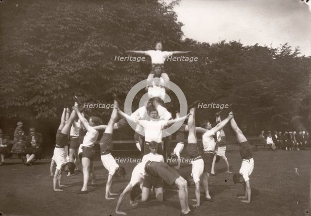 Boys pose in an outdoor gym lesson, 1929. Artist: Unknown