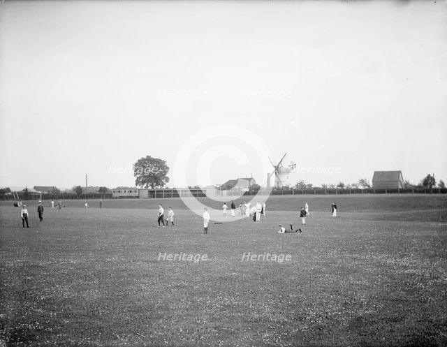 Boys playing cricket, with Thame windmill in the background, Thame, Oxfordshire, c1860-c1922. Artist: Henry Taunt