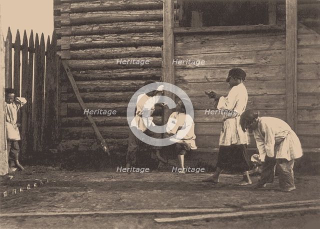 Boys playing Knucklebones, 1860s.