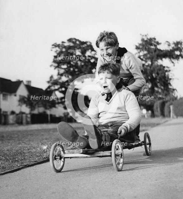 Boys playing with a home-made go-kart, Horley, Surrey, 1965.