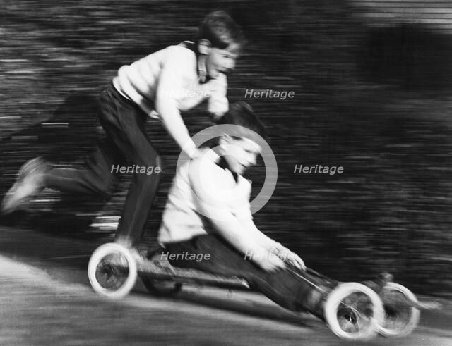 Boys playing with a home-made go-kart, Horley, Surrey, 1965.