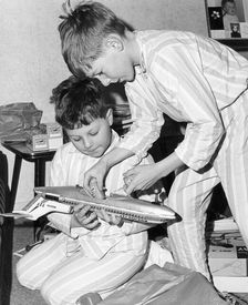 Boys playing with a model plane, c1960s