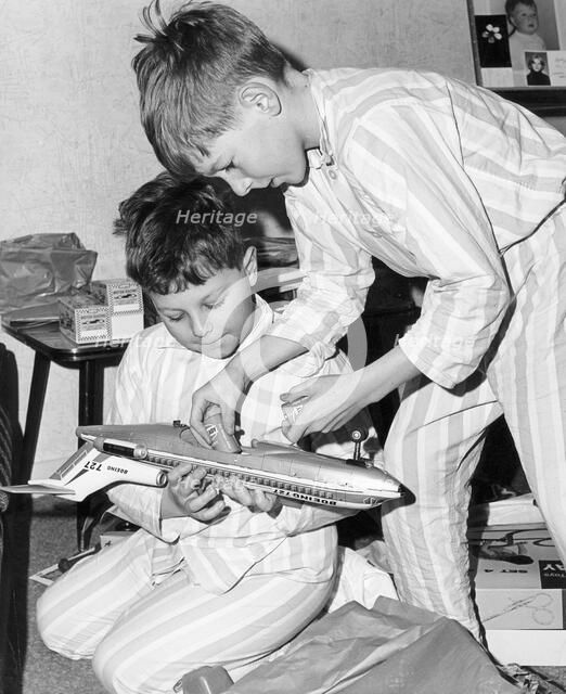 Boys playing with a model plane, c1960s.