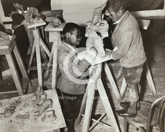 Boys sculpting a horse, Harlem Community Art Center, 1937. Creator: Solomon Horn.