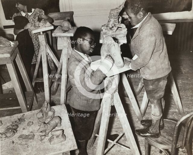 Boys sculpting a horse, Harlem Community Art Center, 1937. Creator: Solomon Horn.