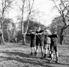 Boys shooting with bows and arrows in Hampstead, London, c1950s. Creator: Henry Grant