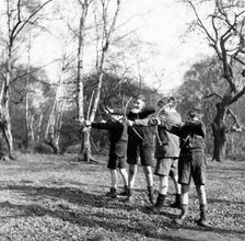 Boys shooting with bows and arrows in Hampstead, London, c1950s. Creator: Henry Grant