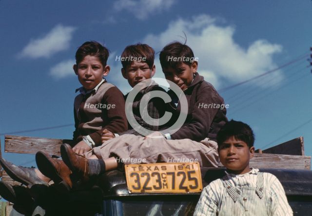 Boys sitting on truck parked at the FSA ... labor camp, Robstown, Tex., 1942. Creator: Arthur Rothstein.