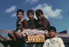 Boys sitting on truck parked at the FSA ... labor camp, Robstown, Tex., 1942. Creator: Arthur Rothstein
