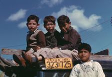 Boys sitting on truck parked at the FSA ... labor camp, Robstown, Tex., 1942. Creator: Arthur Rothstein