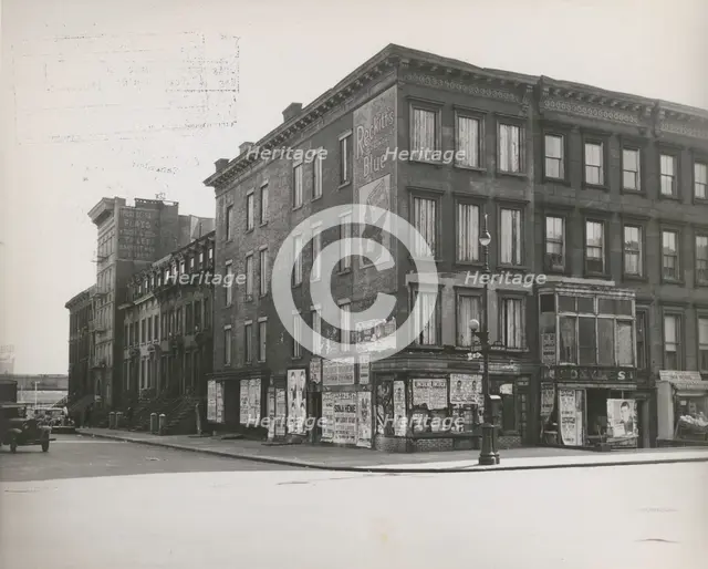 Boarded residential building on the corner of Madison Avenue and East 133rd Street..., 1938. Creator: Aubrey Pollard.