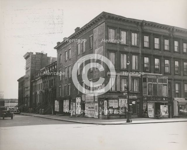 Boarded residential building on the corner of Madison Avenue and East 133rd Street..., 1938. Creator: Aubrey Pollard.