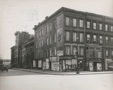 Boarded residential building on the corner of Madison Avenue and East 133rd Street..., 1938. Creator: Aubrey Pollard